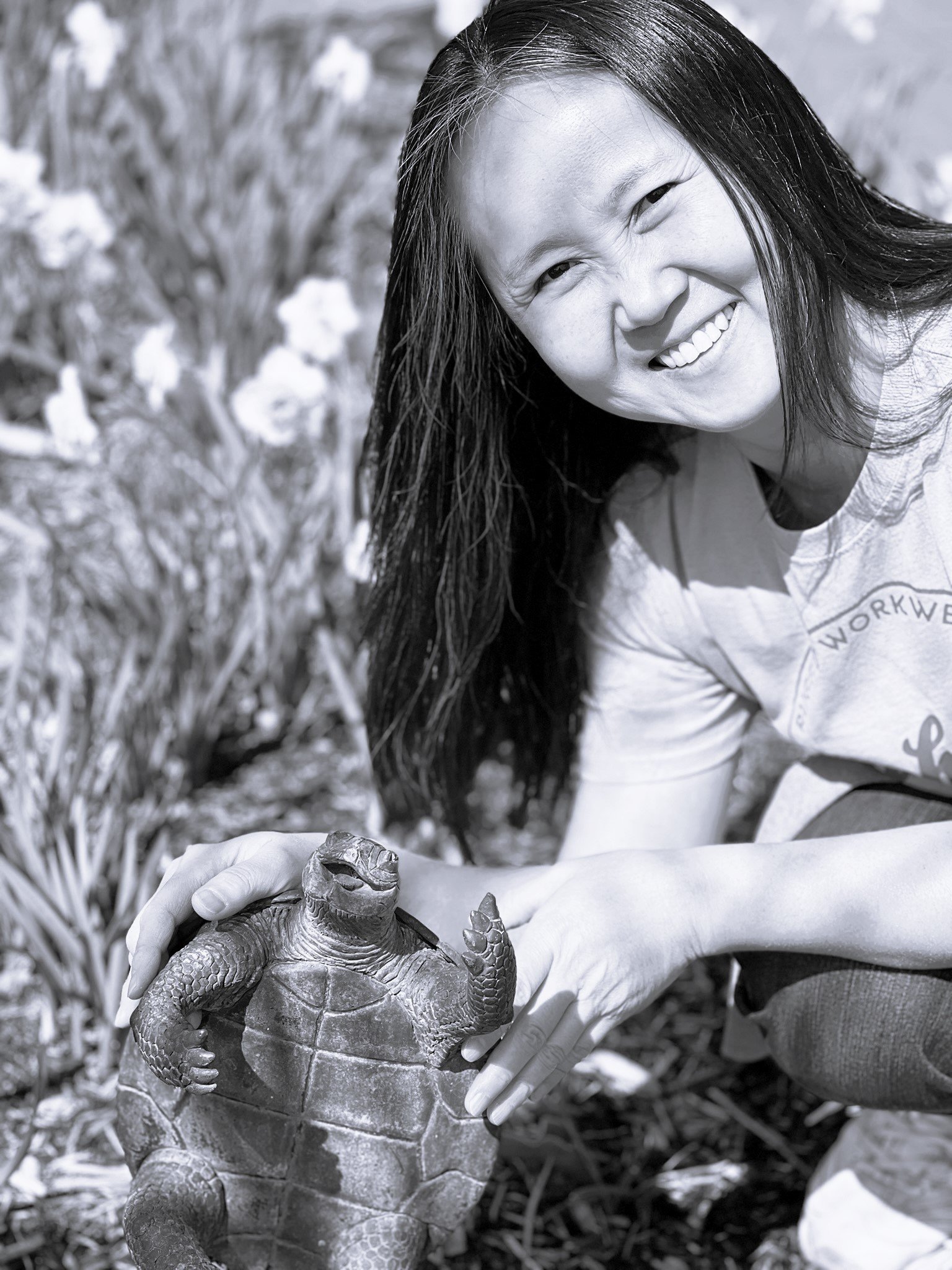 Korean language tutor next to little turtle statue. 